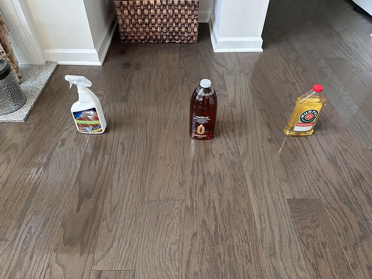 Three of the best wood cleaners on a wood floor before testing.