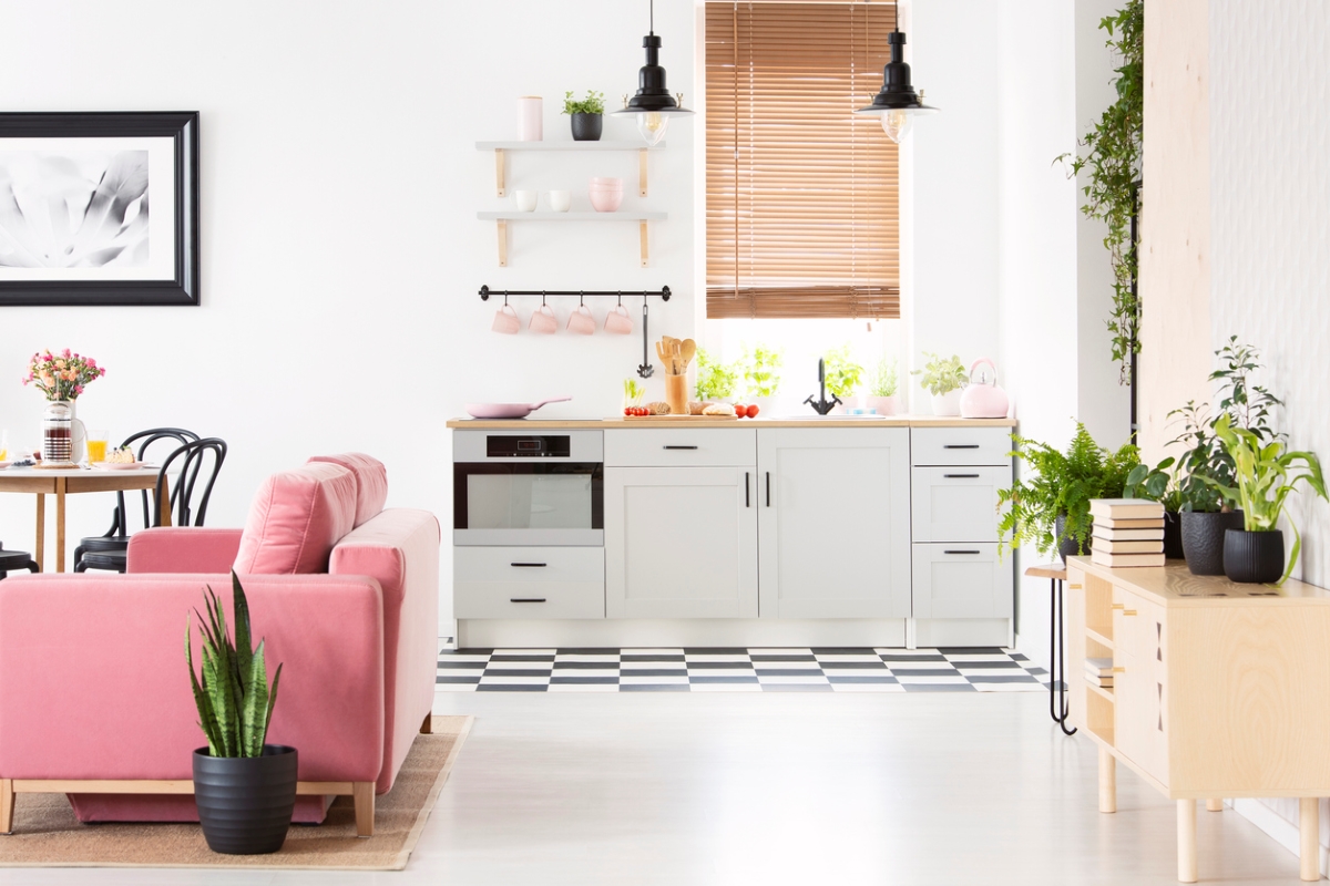 Small kitchen near pink couch.