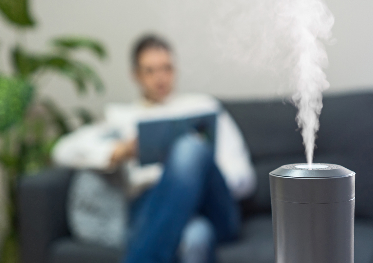 Dehumidifier on with person blurred in background