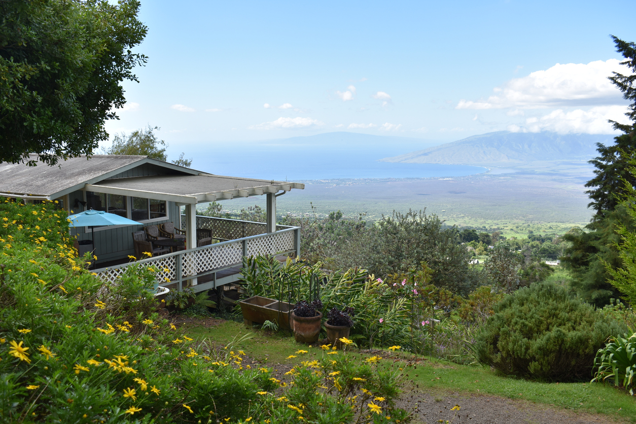 house on hill in hawaii with a view of mountains beach and ocean