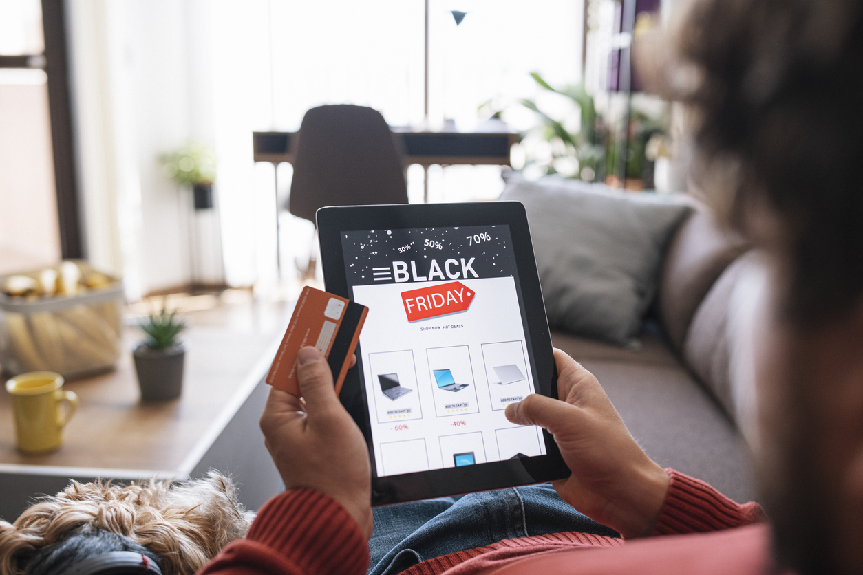 A person scrolls through Black Friday deals on a tablet.