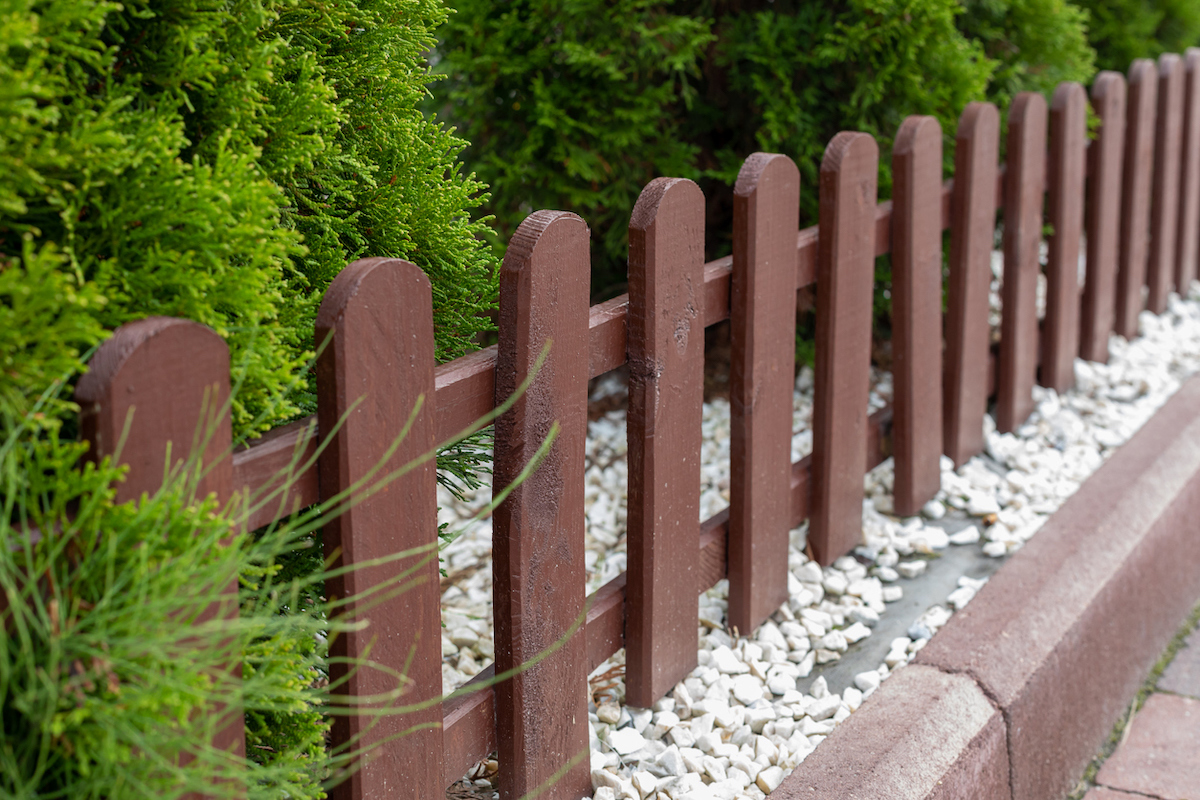 short picket fence along garden bed