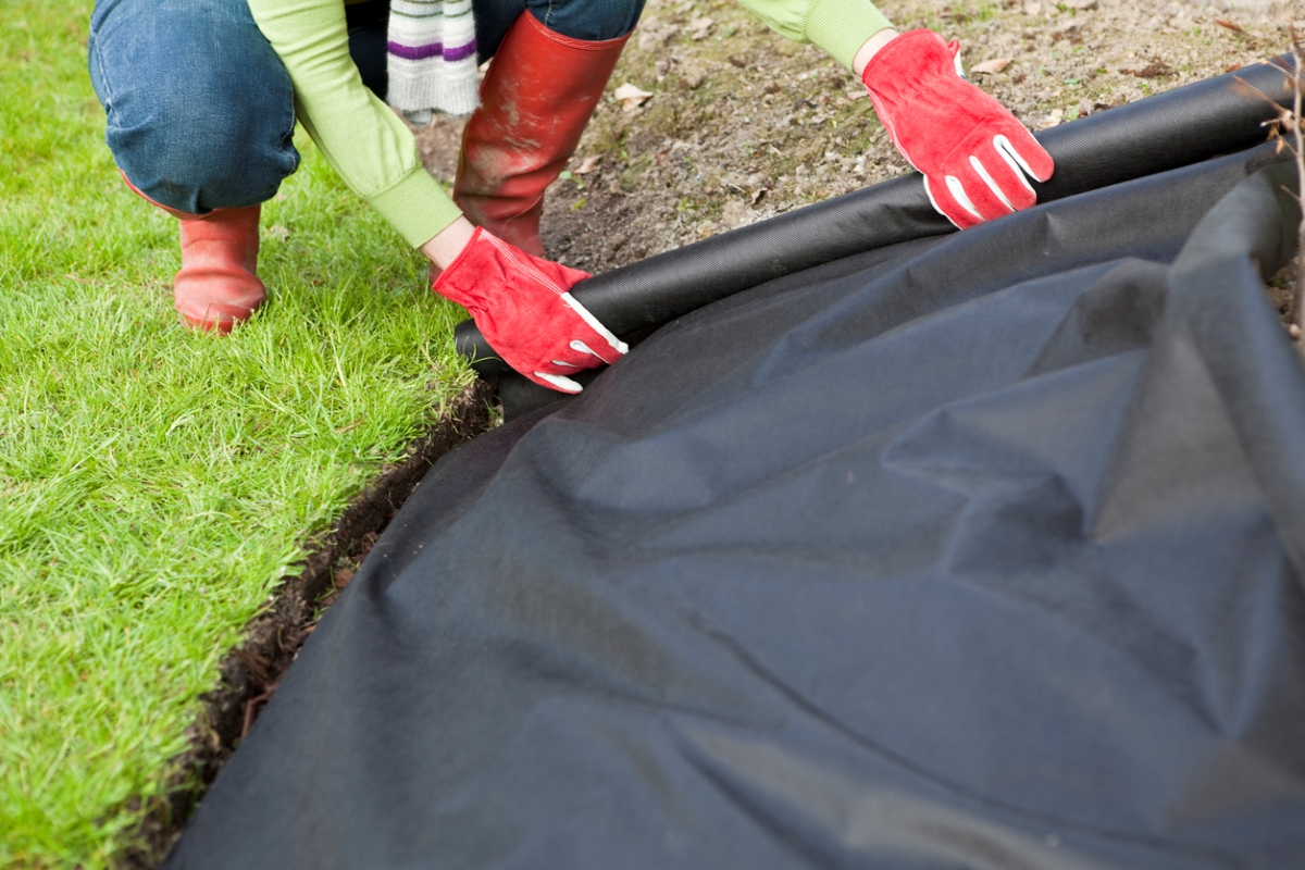 Person laying landscape material