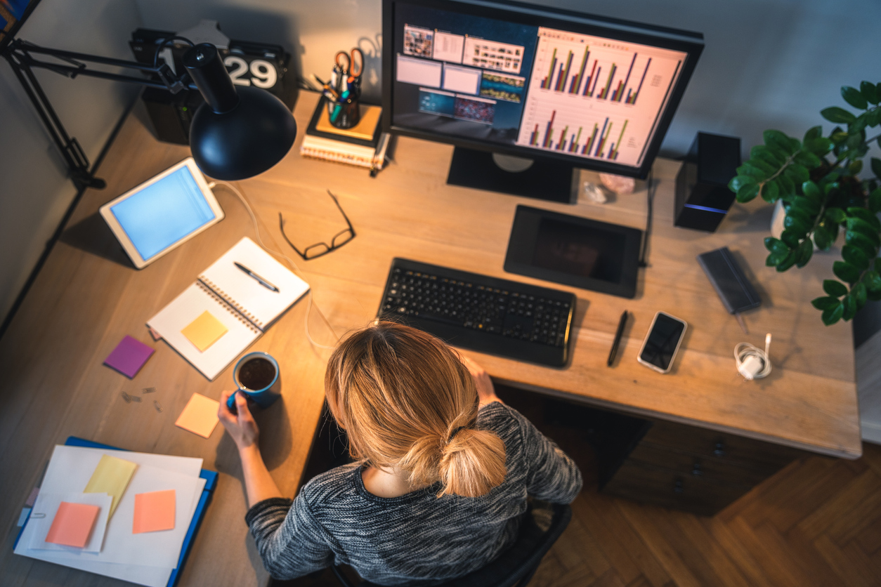 modem vs router overhead shot woman at desk home office desktop multiple devices