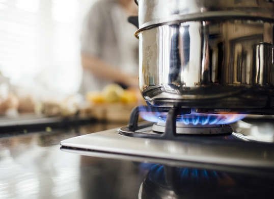 close up of gas burner and pot on the stove