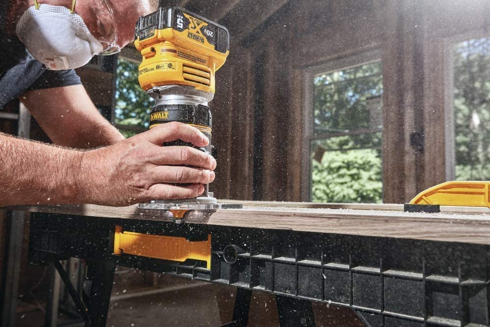 A person using the best wood router for beginners to route the edge of a board.