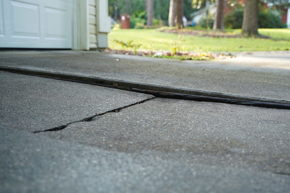 Soil under a cement driveway shifted, causing a sagging foundation.