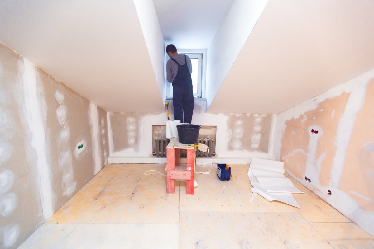 A view of a worker finishing a second story under construction. 