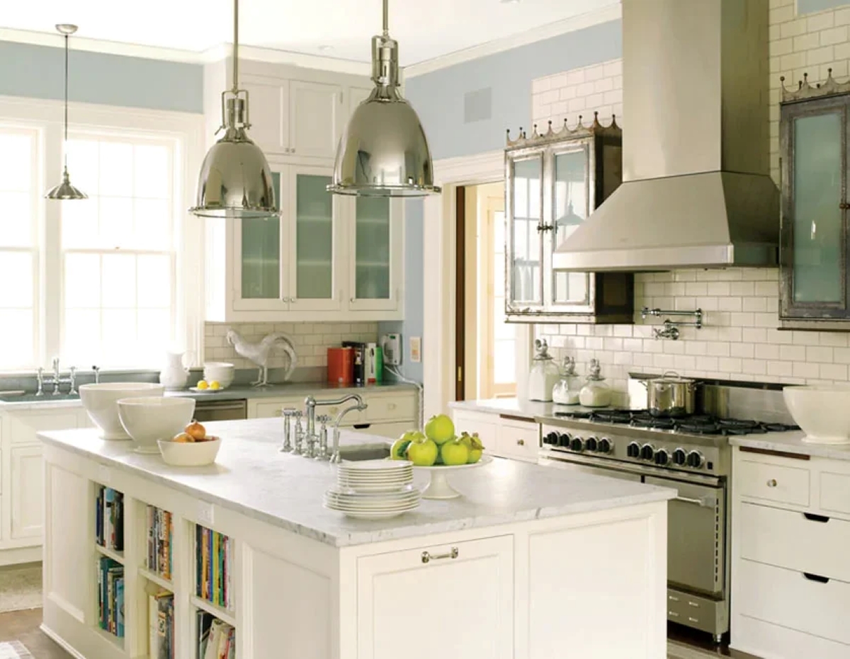 Kitchen with large island painted in swiss coffee color.