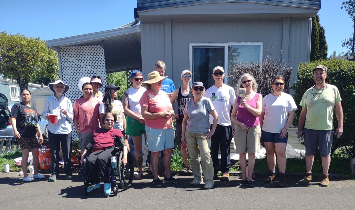 Volunteers in Washington County Oregon stand in front of a home they painted.