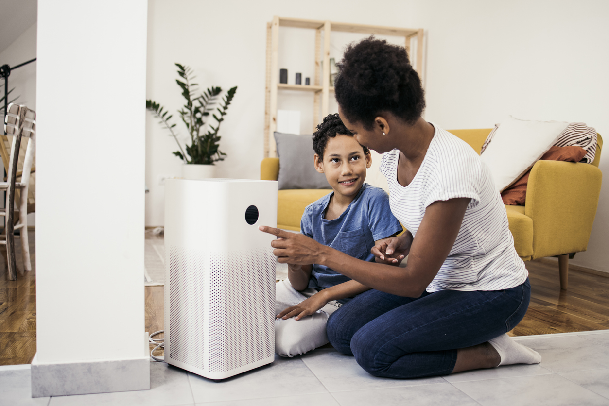 iStock-1338702572 must dos December woman and son setting up air filter