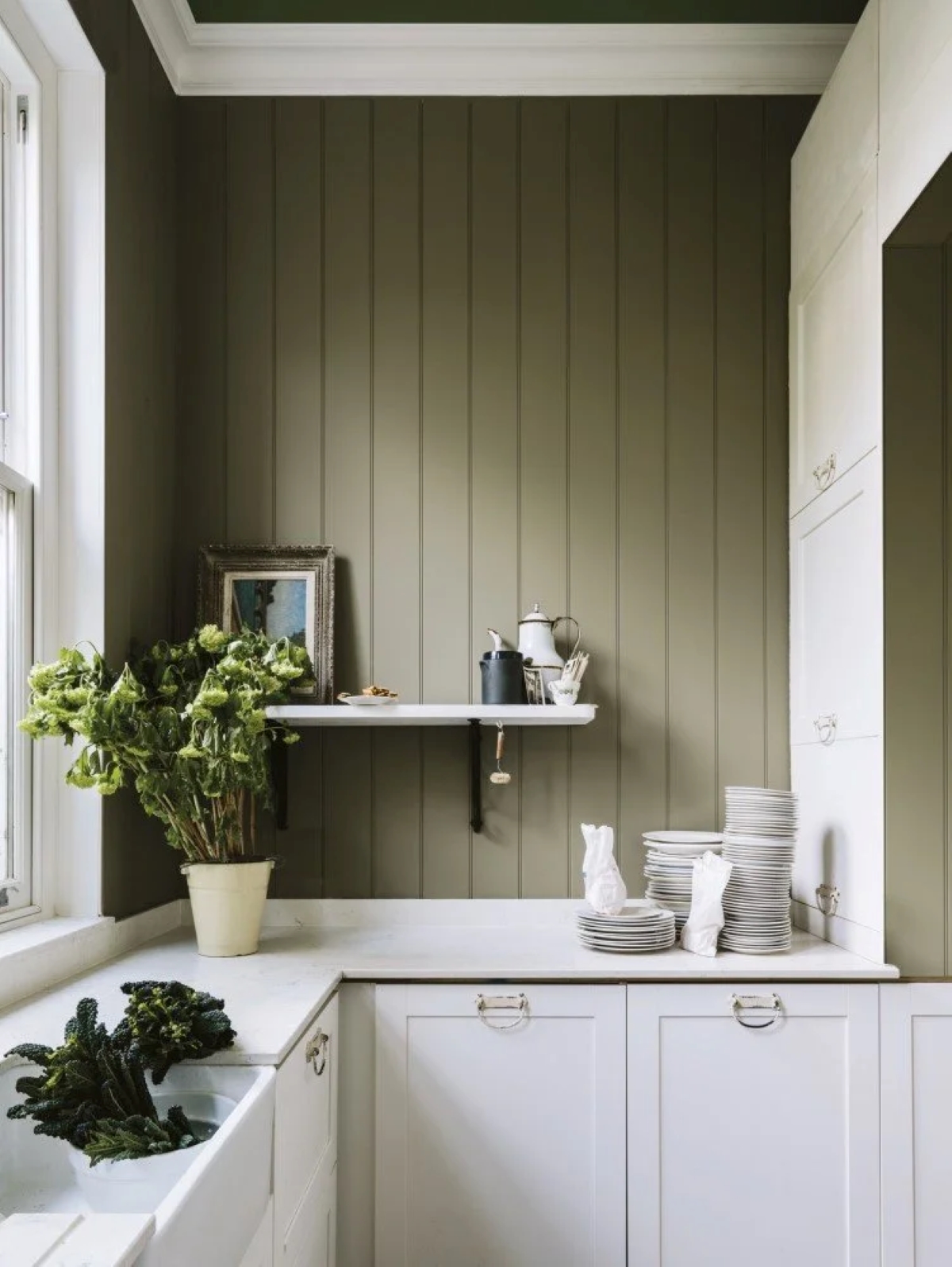 Kitchen with green wall.