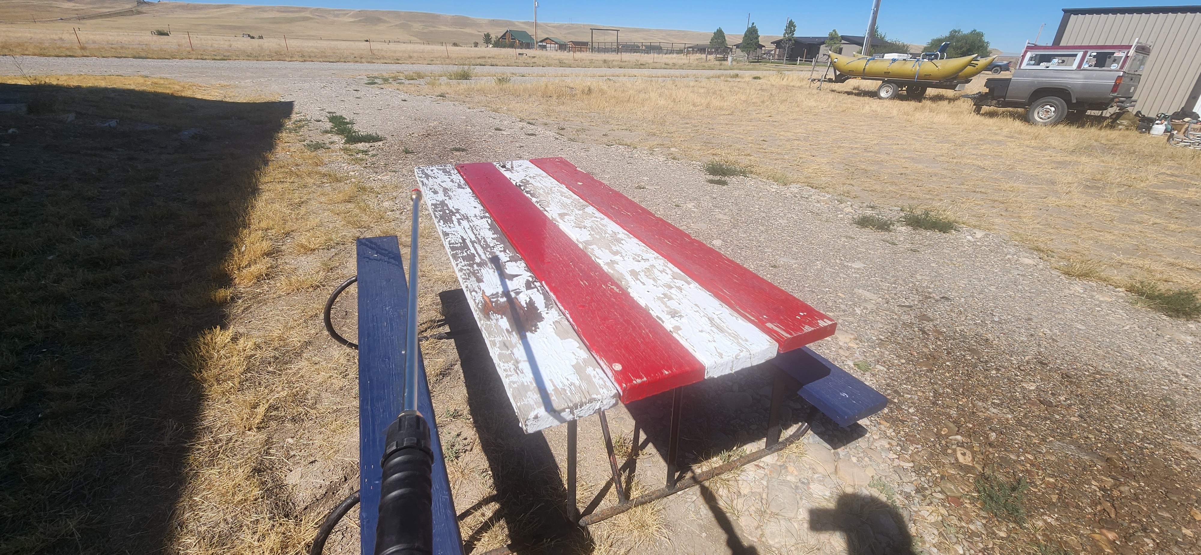 Photo of a picnic table as it's being pressure washed