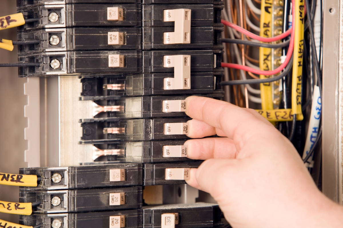 Person turning off circuit breaker.