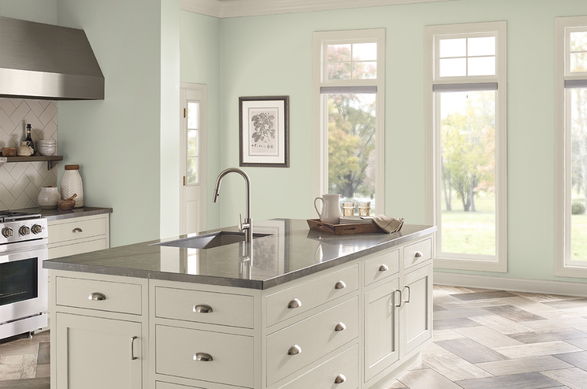 Kitchen with light green walls.