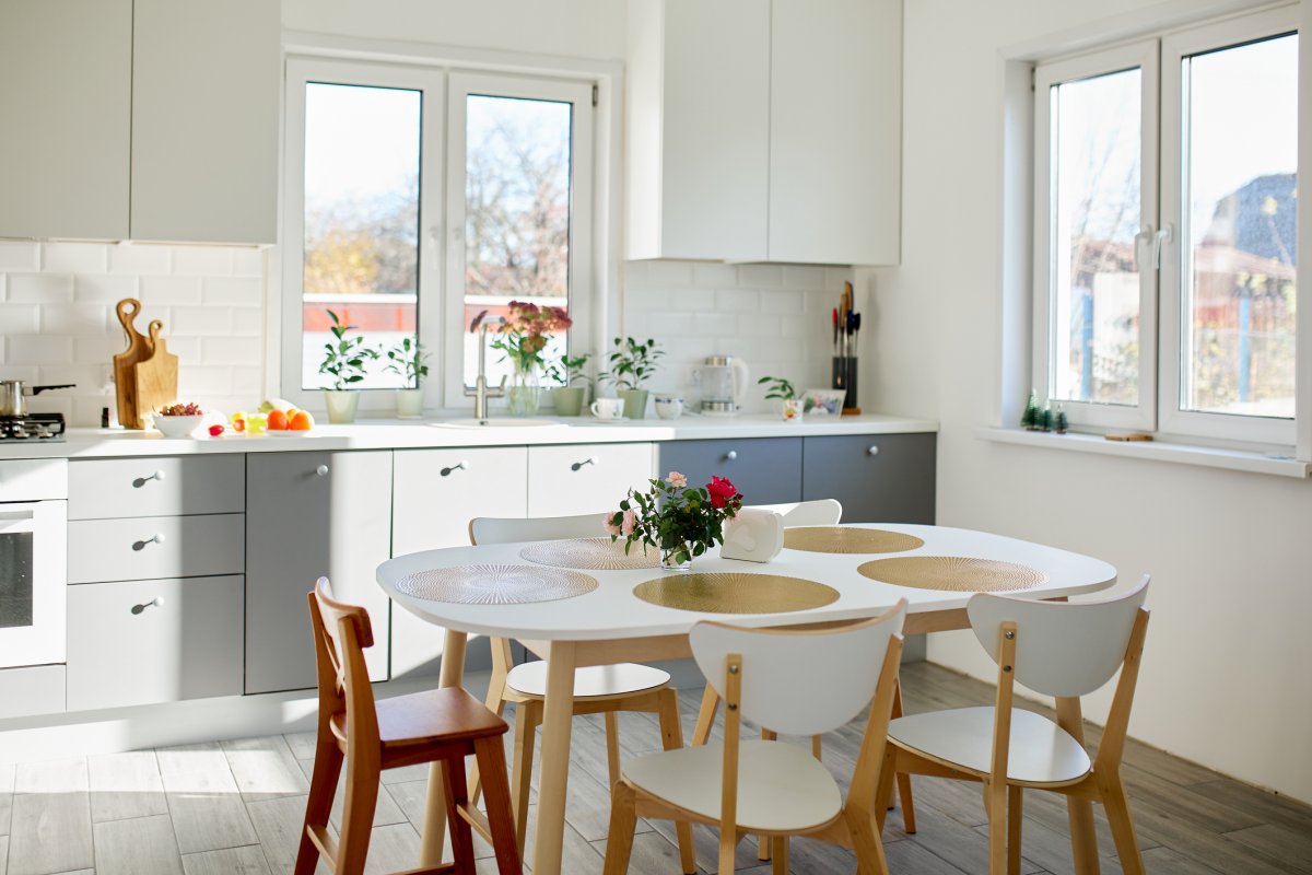 Bright kitchen with a table and chairs near a window.