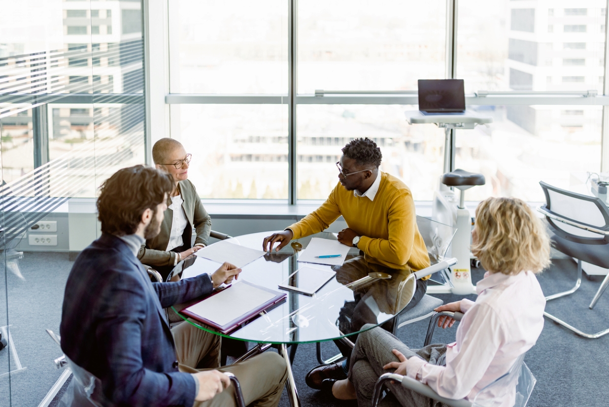 how to choose a rental property - group of four people working around table