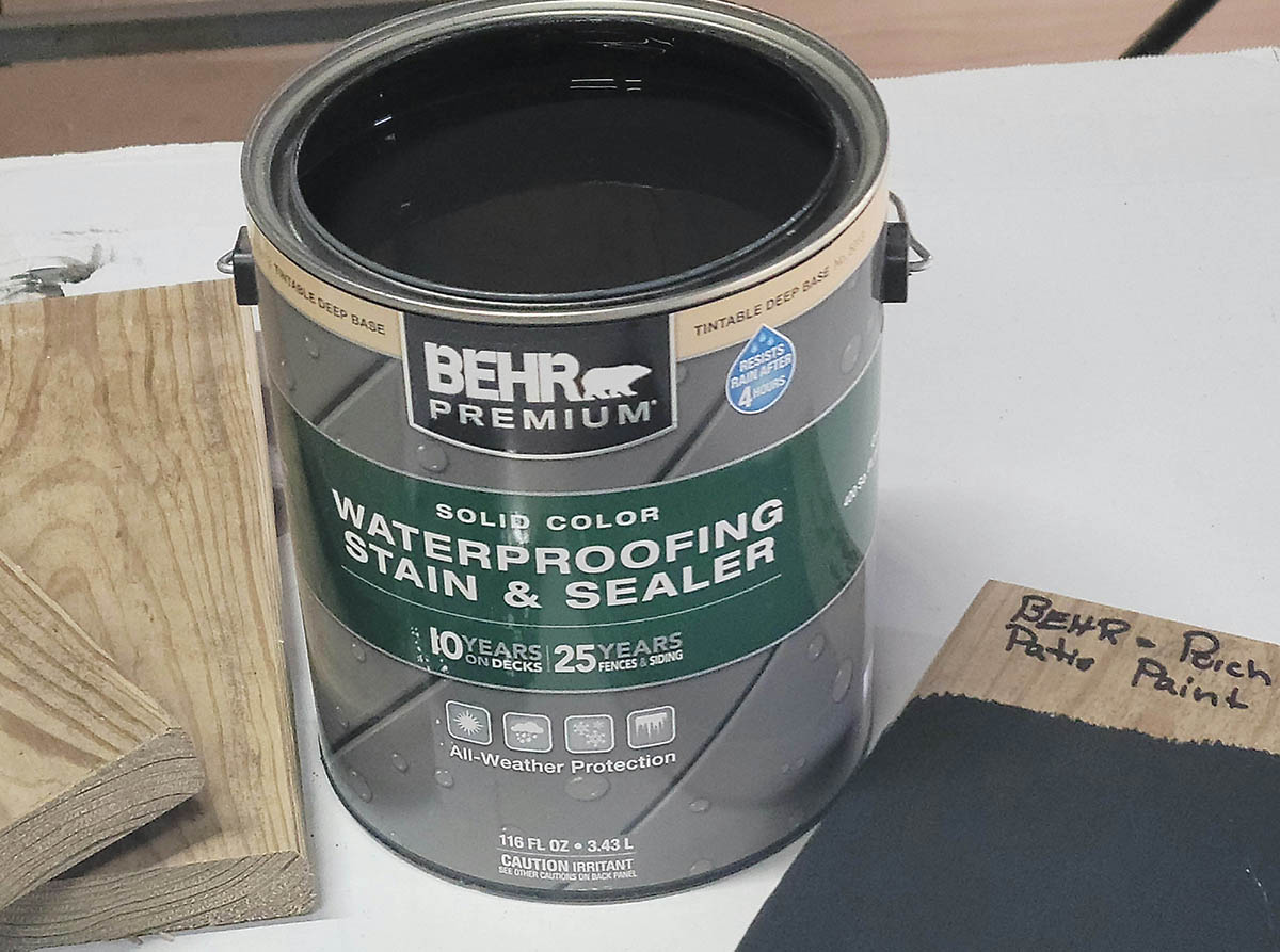 Un pot de peinture pour terrasse Behr ouvert sur une table blanche