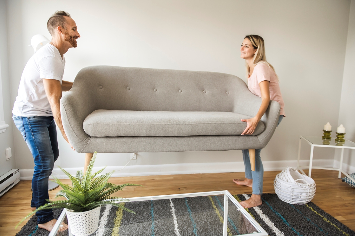 Couple bringing in couch