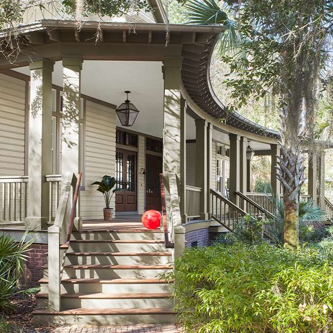 A covered front porch is painted in tones of beige.