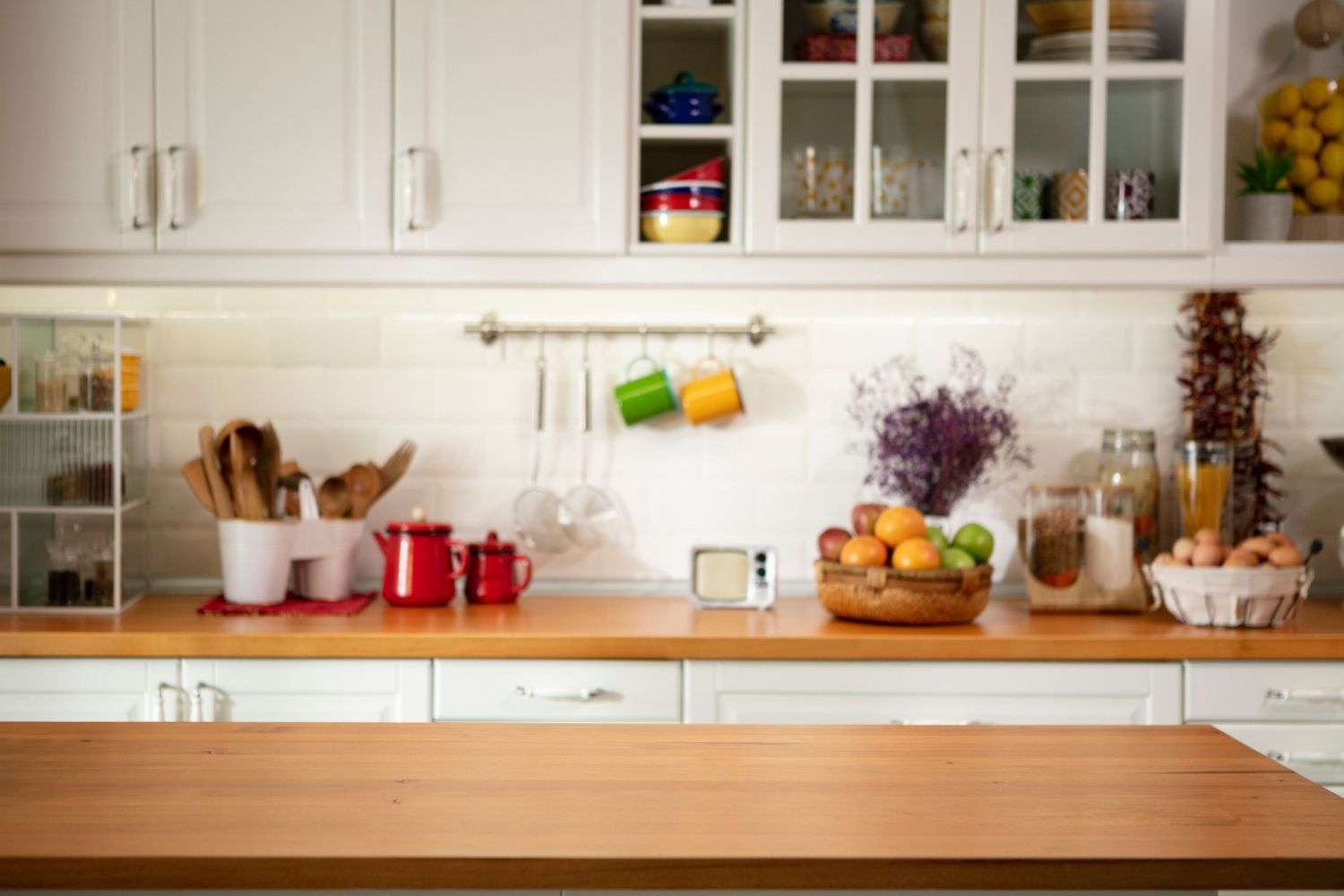 A view of a beautiful kitchen with white cabinets. 