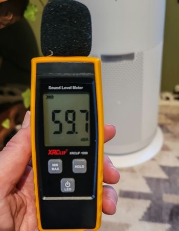 Woman measuring the noise from a Shark air purifier