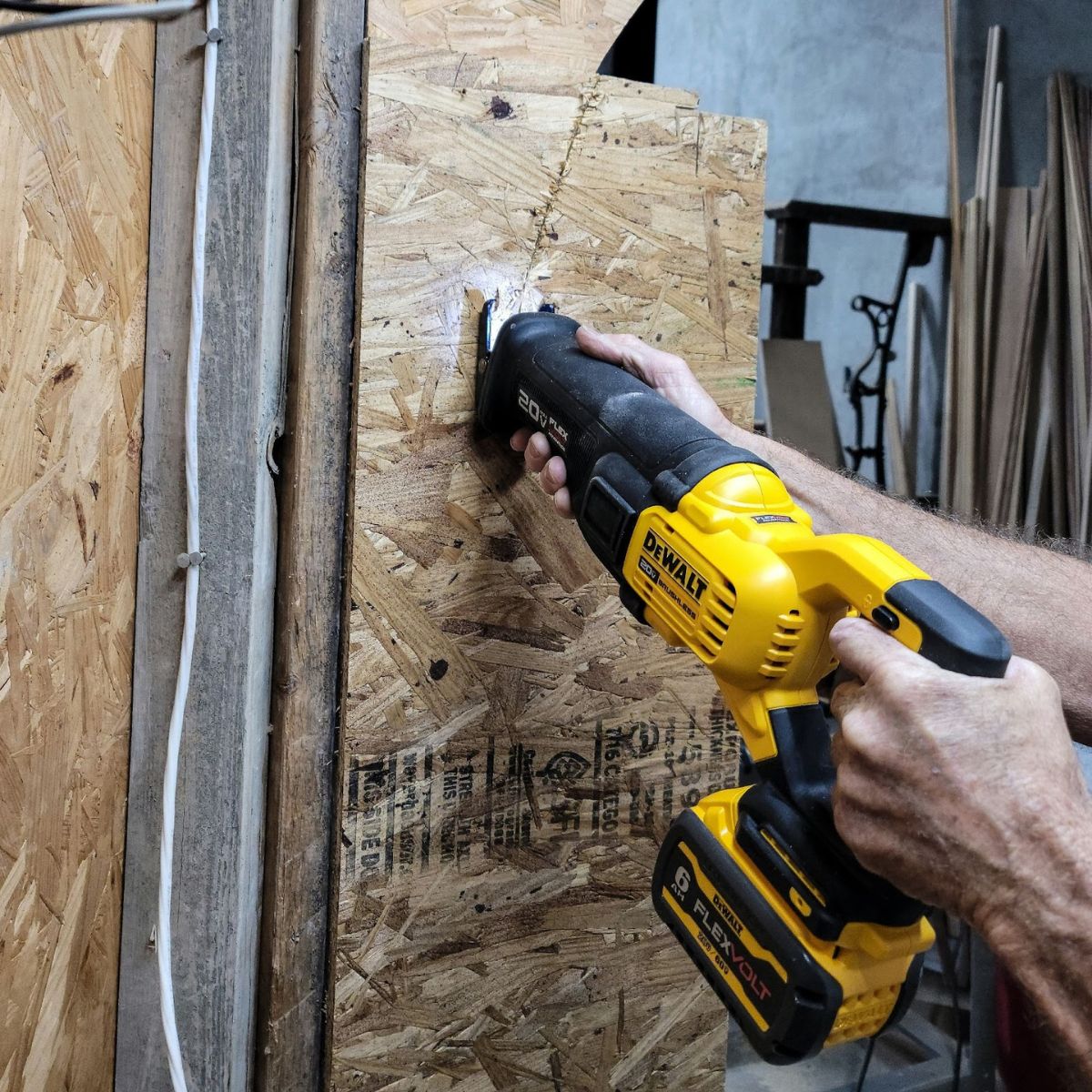 DeWalt reciprocating saw cutting through plywood