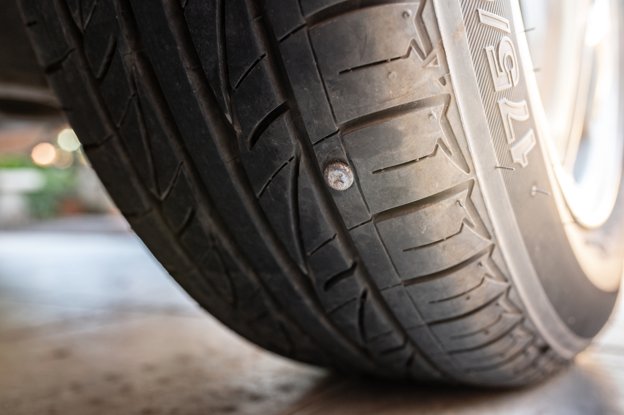 Close-up nail or screw stick on the car tire