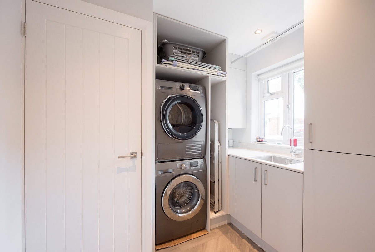 View of home laundry rooms with stainless steel appliances.