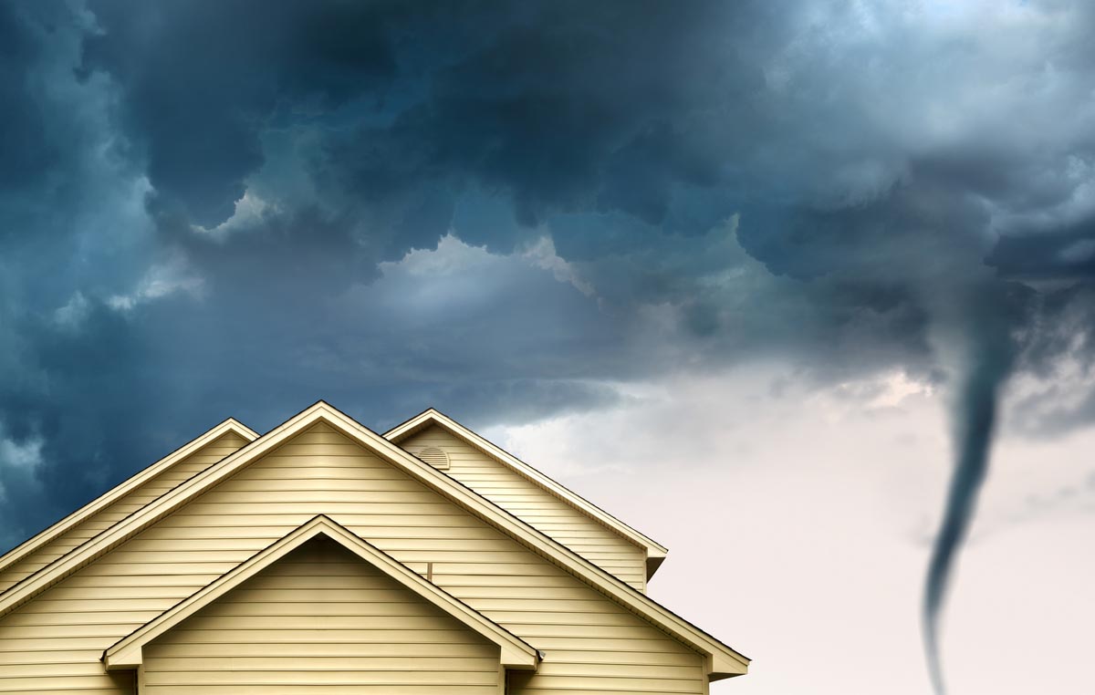 A view of a tornado and home's roof. 