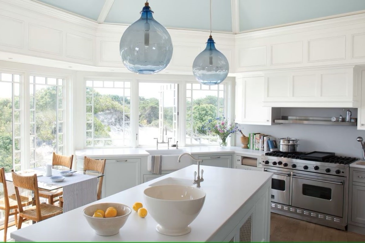 A large kitchen with light blue ceiling.