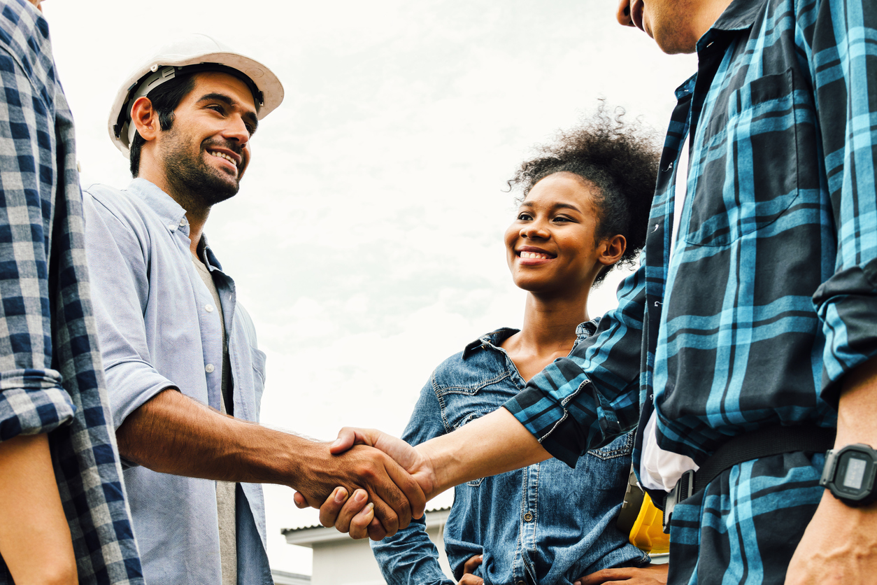 Multi-racial-contractors-shake-hands-and-smile.