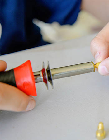 Person placing tip on TRUArt Stage 1 Pyrography Pen