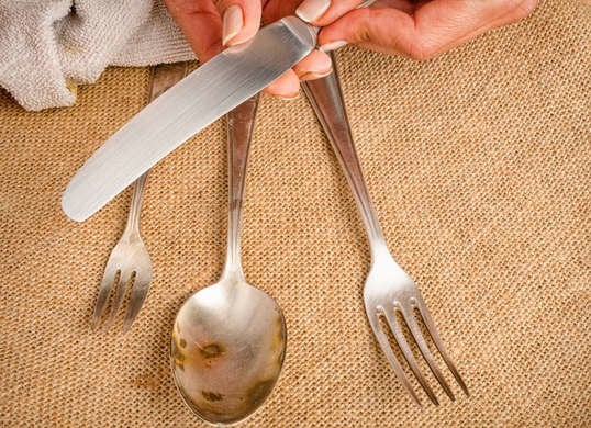 Stained silverware on table