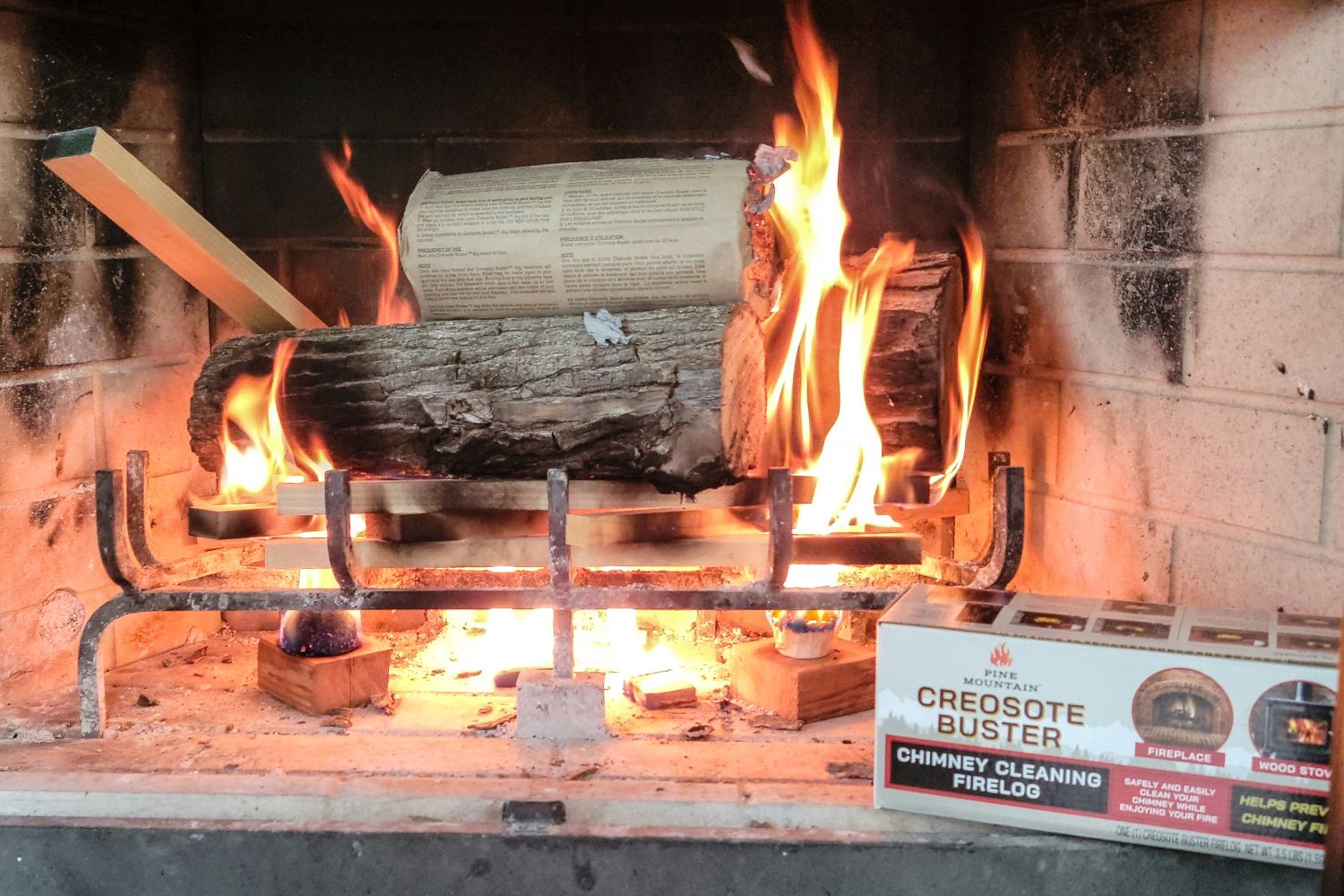 The Pine Mountain Creosote Buster Fire Log on top of a fire burning in a fireplace with its box positioned nearby.The Pine Mountain Creosote Buster Fire Log on top of a fire burning in a fireplace with its box positioned nearby.The Pine Mountain Creosote Buster Fire Log on top of a fire burning in a fireplace with its box positioned nearby.The Pine Mountain Creosote Buster Fire Log on top of a fire burning in a fireplace with its box positioned nearby.The Pine Mountain Creosote Buster Fire Log on top of a fire burning in a fireplace with its box positioned nearby.