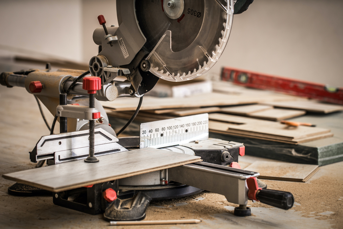 sliding compound miter saw cutting flooring