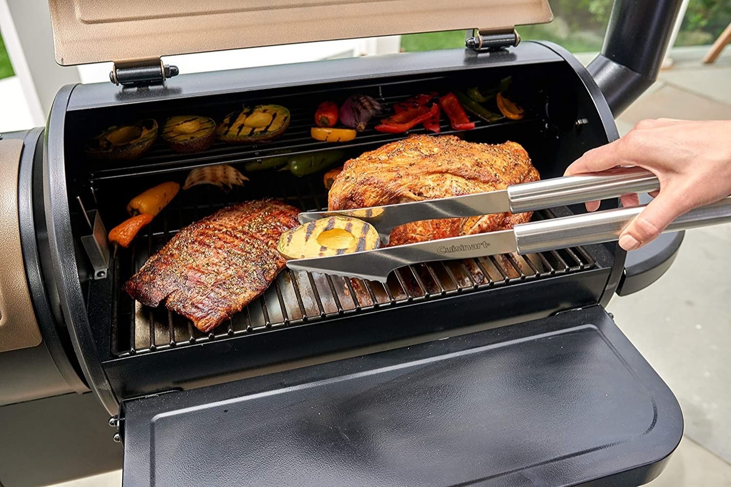 Person grabbing an avocado off of a grill with Cuisinart tongs