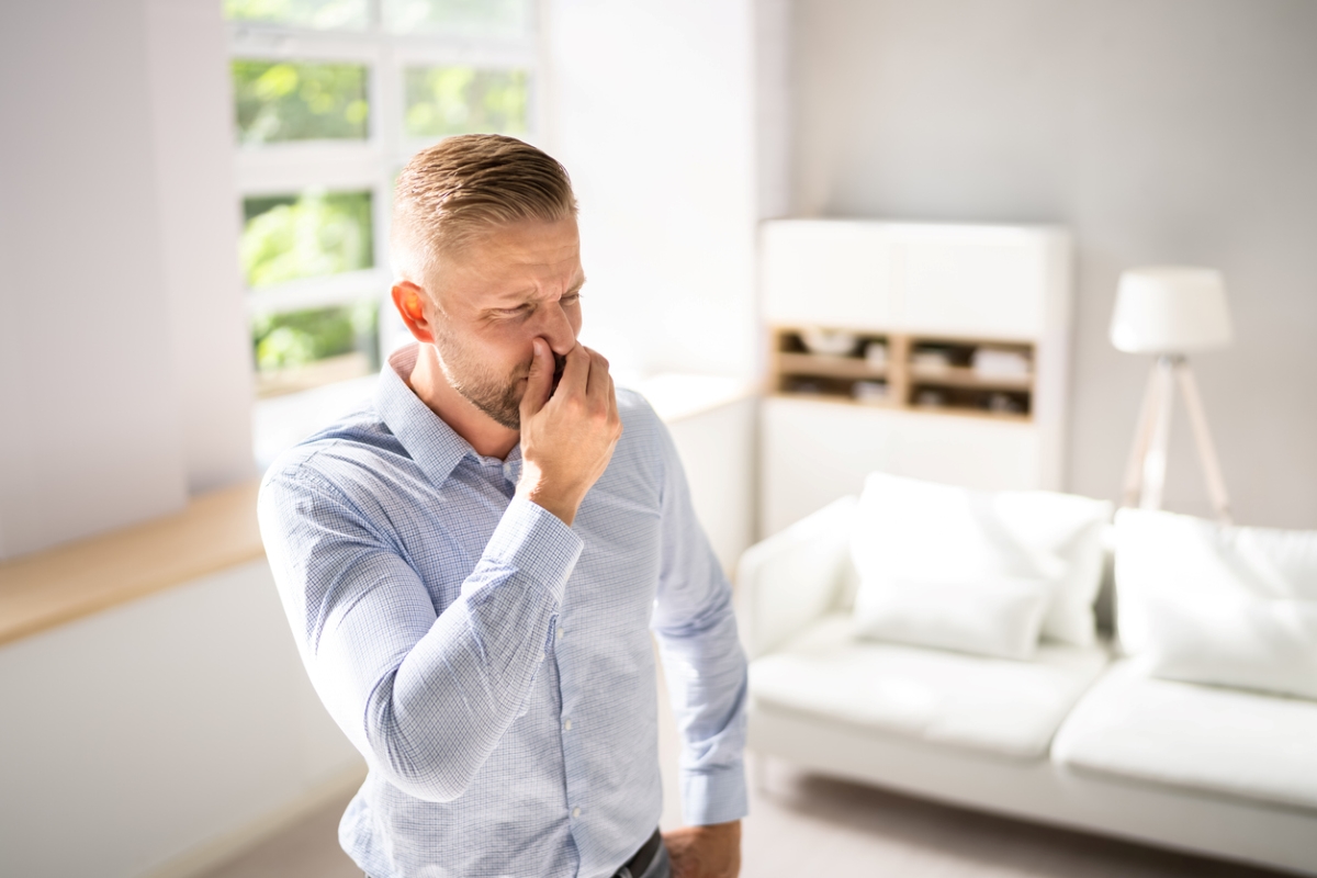 Man holding nose