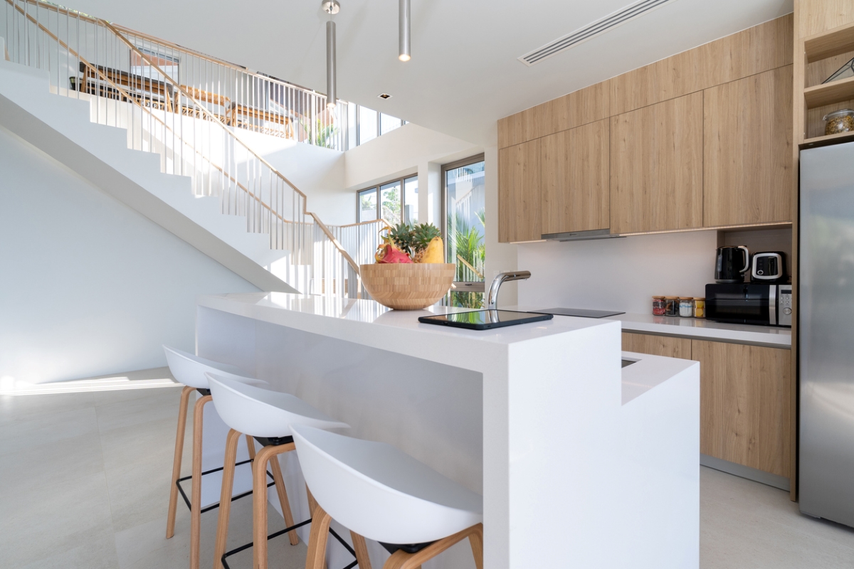 Small kitchen with small white island.