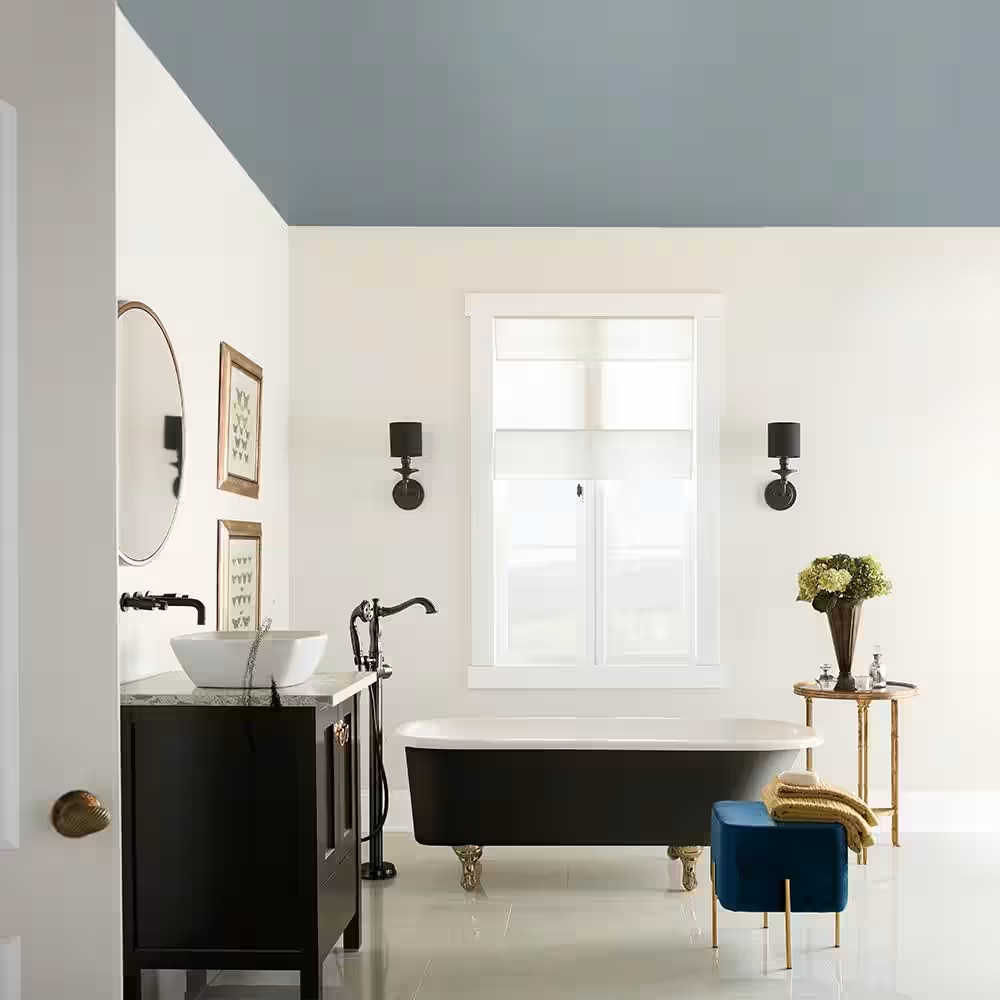 Modern bathroom with blue and gray tone ceiling.