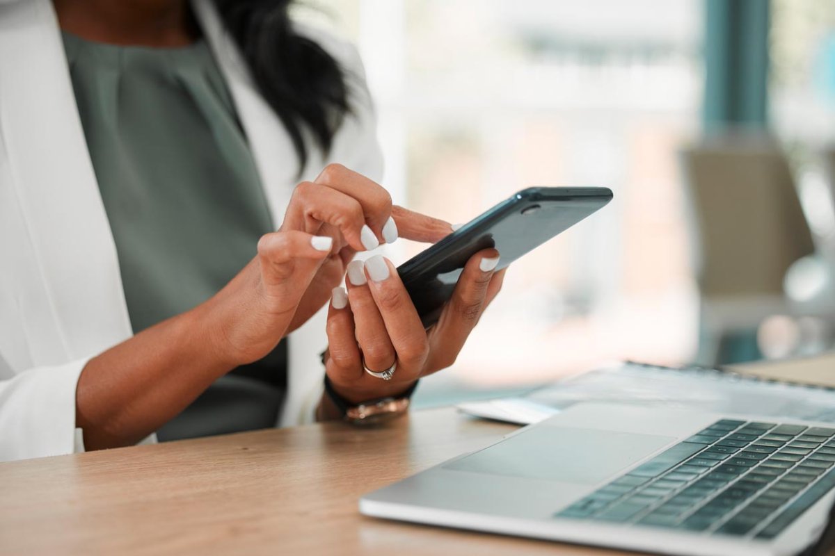 A close up of a woman browsing on a smart phone. 