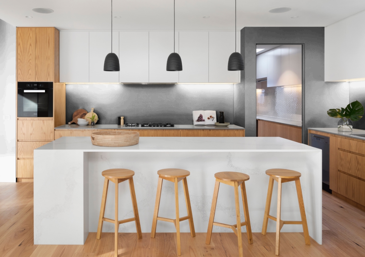 A kitchen with a large island and tools and white ceiling. 