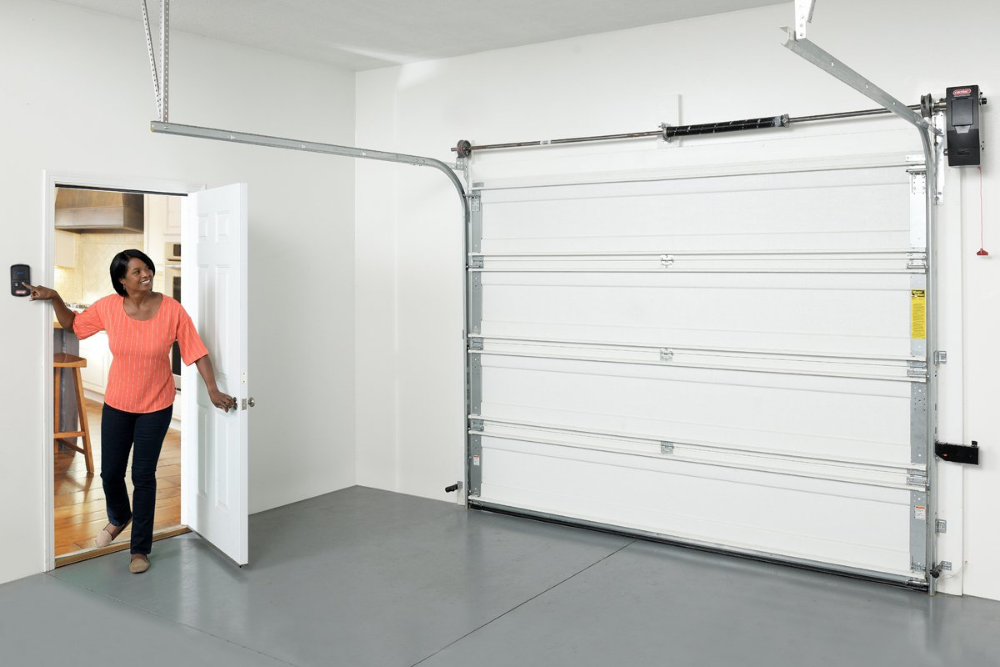 A person looking out from the house into a garage equipped with the best garage door openers option