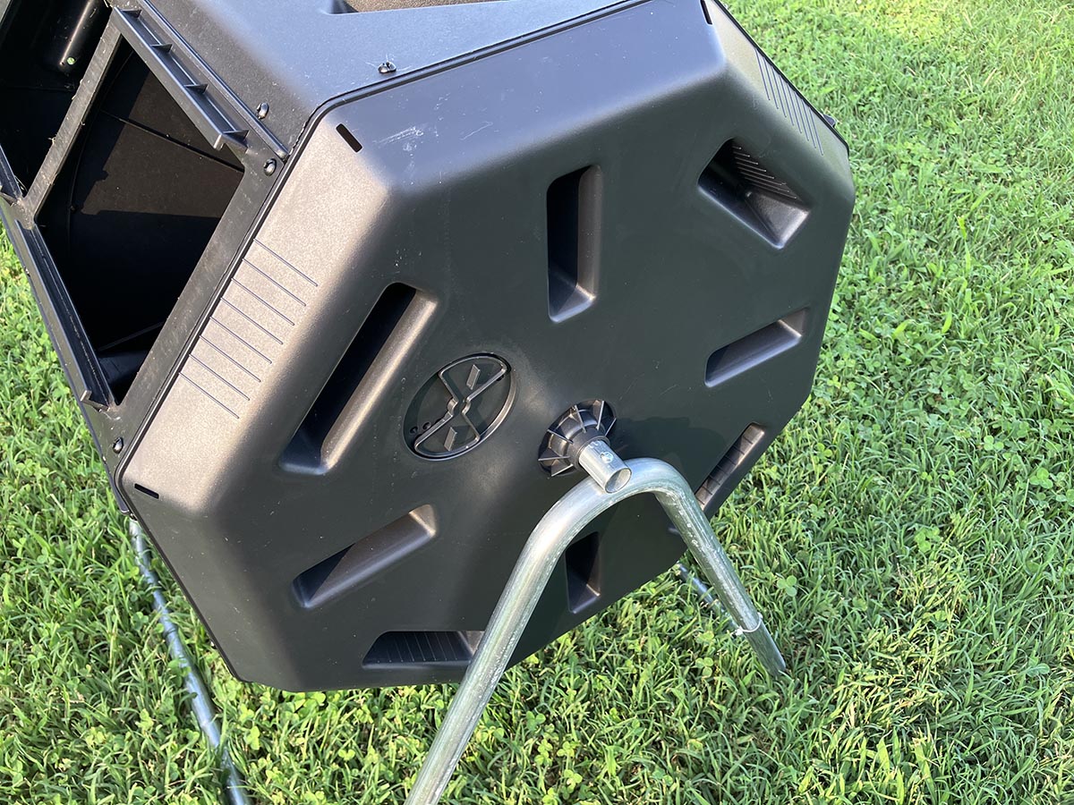 A close-up of the stand and handles on the FCMP Outdoor tumbling composter