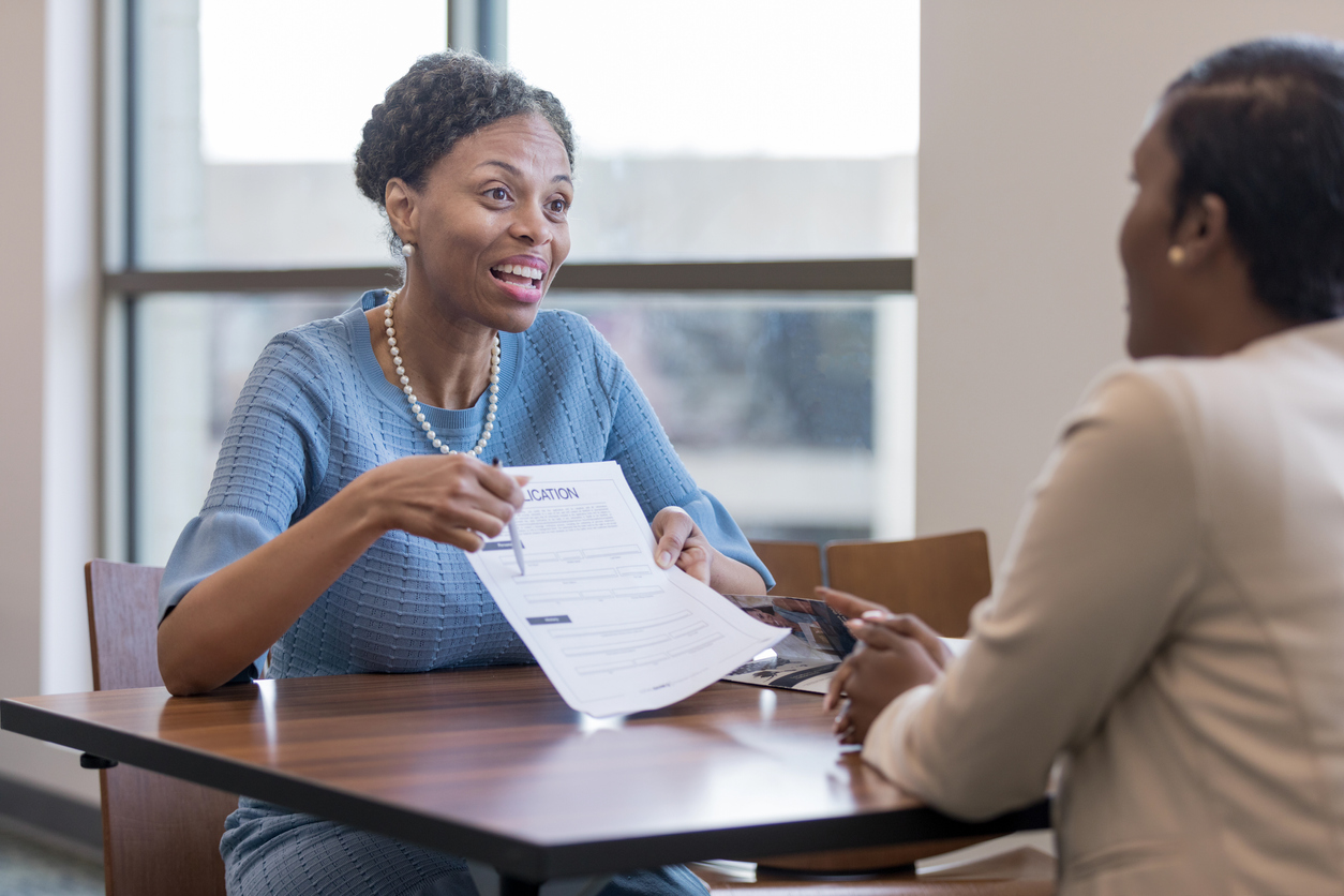 Senior female personal banker shows client account application