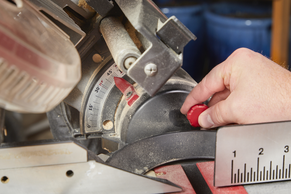 Adjusting the angle to make a bevel cut with a miter saw.