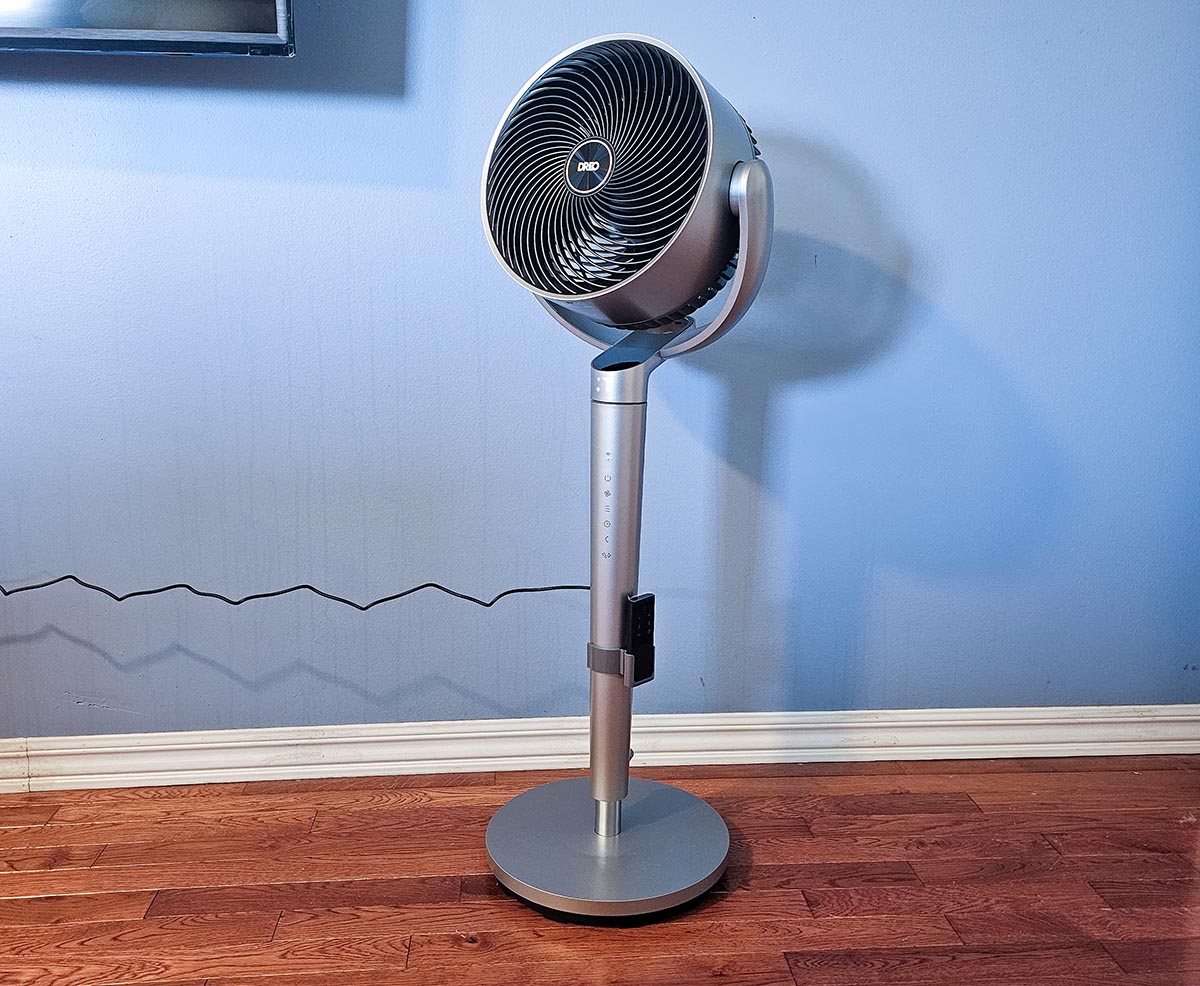 The best pedestal fan in front of a blue wall during testing.