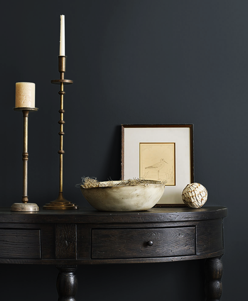 dark colored hallway table against dark colored wall