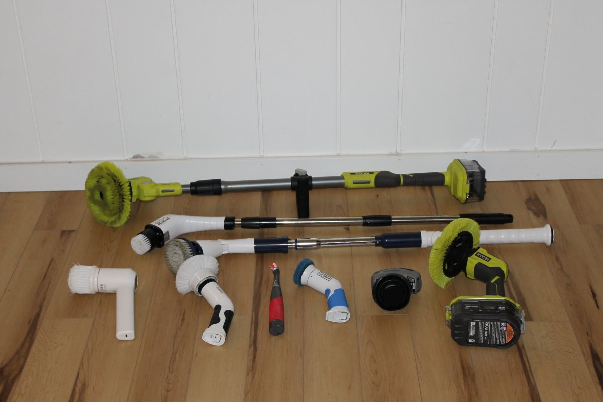 Nine of the best power scrubbers laying side by side on a wood floor