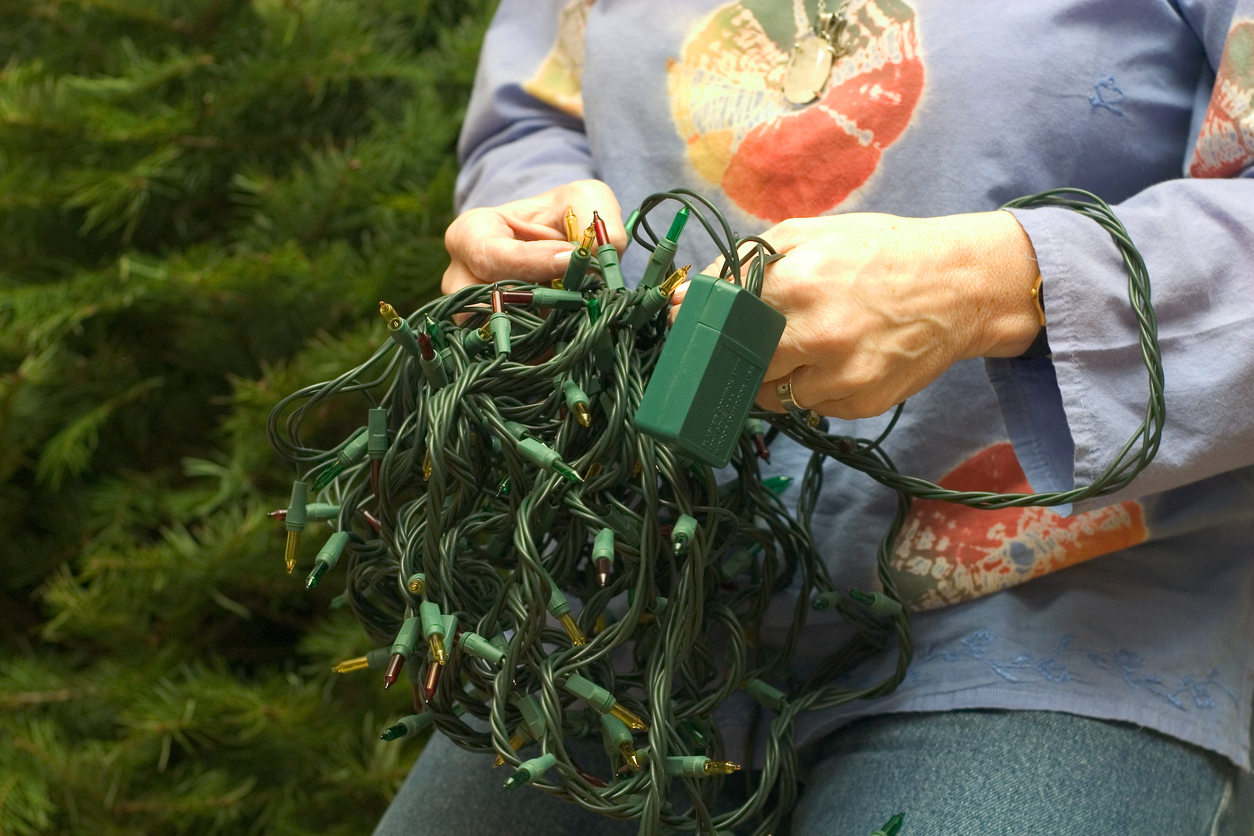 close up of woman testing Christmas lights